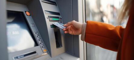 The ATM transaction as a person uses a card for cash withdrawal. photo