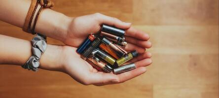 The hands holding a variety of batteries showcasing energy and technology. photo