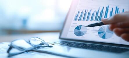 The detailed analysis of business statistics on a laptop screen. photo