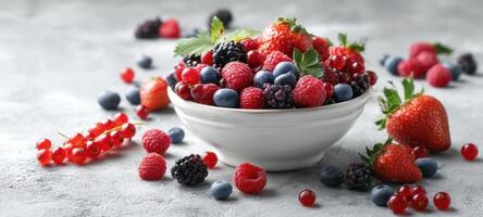 The vibrant assortment of fresh berries in a white bowl. photo
