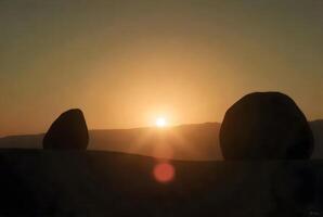 Tranquil Desert Sunset with Rock Formations and Distant Mountains in Warm Light Scenery photo