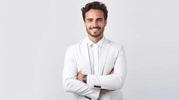 A man in a white suit standing with his arms crossed photo