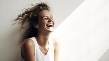 A woman laughing in front of a wall photo