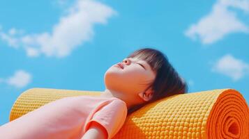 Dreamy Baby Girl Stretching on Neon Yoga Mat Under Bright Blue Sky with Soft Clouds photo