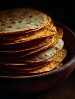 A Stack of Golden Brown Flatbreads in a Rustic Bowl. photo