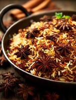 Aromatic Spiced Rice Dish in a Dark Bowl, Close Up. A tempting image of flavorful rice with star anise and other spices. photo