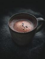 Close Up of Frothy Hot Chocolate in a Rustic Mug. photo