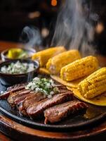 Sizzling Steak with Grilled Corn and Tortillas. A close up of a delicious meal. photo
