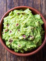 Delicious Guacamole in a Rustic Bowl A Close Up View of Creamy Avocado Dip. photo