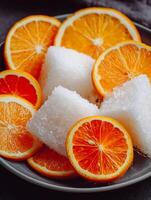 Close Up of Juicy Orange Slices and White Cubes on a Plate. photo