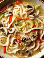 Close Up of Delicious Udon Noodle Soup with Mushrooms and Vegetables. photo