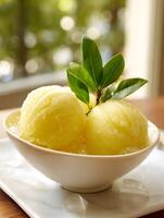 Refreshing Lemon Sorbet in a Bowl with Ice and Garnish. A close up image of two scoops of delicious lemon sorbet. photo