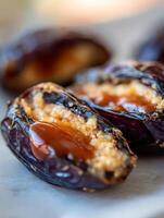 Close up of Dates Stuffed with Peanut Butter and Caramel Sauce. photo