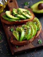 Delicious Avocado Toast with Sesame Seeds and Parsley. A close up image of two slices of toasted bread topped with fresh avocado, sesame seeds, and parsley. photo