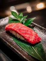 Close up of a single piece of fresh red tuna sushi on a leaf. photo