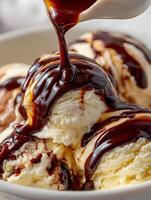 Close Up of Vanilla Ice Cream with Rich Chocolate Sauce Drizzled Over. photo