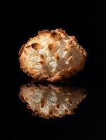 Close up of a Single Delicious Coconut Macaroon Cookie on Black Background. photo