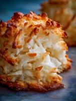 Close up of a Delicious Coconut Macaroon Cookie, Partially Broken to Reveal its Flaky Texture. photo