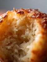Close up of a Coconut Macaroon, showing its Texture and Golden Brown Crust. photo