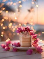 A slice of vanilla cake adorned with bougainvillea flowers, set against a dreamy sunset bokeh background. photo