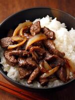 Delicious Beef and Onion Stir-fry Served over Fluffy White Rice. photo