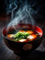 Steaming Bowl of Miso Soup with Tofu and Scallions. A close up image of a delicious and healthy Japanese soup. photo