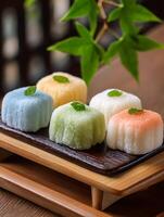 Close up of Colorful Mochi Sweets on Wooden Tray. A delectable image of traditional Japanese mochi treats, perfect for food blogs and culinary publications. photo
