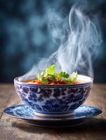 Steaming Bowl of Lentil Soup with Cilantro Garnish. A close up image of a delicious and healthy lentil soup, served in a beautiful blue and white bowl. photo