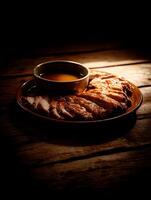 Sliced Roasted Pork with Savory Sauce on Rustic Wooden Table. A close up image of a delicious meal. photo