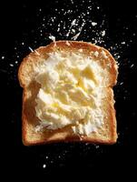 Close up of Buttered Toast with Butter Splashing. A delicious image of a slice of toasted bread with butter melting and splashing. photo