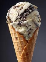 Close up of a delicious ice cream cone with chocolate chunks. A mouthwatering image perfect for summer and dessert menus. photo