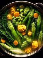 Overhead close up of a pot of vibrant vegetable soup, featuring broccoli, corn, carrots, and various greens. photo