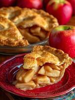 A Slice of Homemade Apple Pie on a Red Plate with Apples in the Background. photo