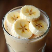 Banana Smoothie in Glass with Sliced Fruit Topping photo