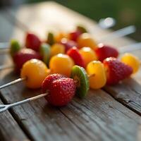 Fruit Skewers with Strawberries Kiwi and Yellow Tomatoes on Wood Surface photo