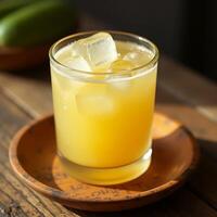Refreshing Cold Drink with Ice Cubes on Wooden Table photo