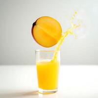 Pouring Fruit Juice Into Glass with Splash on White Table photo