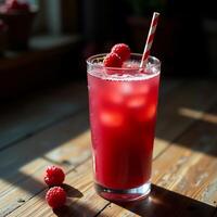 Refreshing Raspberry Drink with Ice and Striped Straw on Wooden Table photo