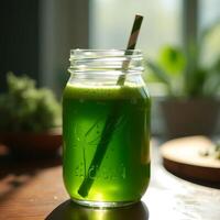 Fresh Green Juice in Glass Jar with Straw on Wooden Table photo