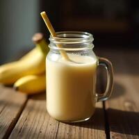 Banana Smoothie in Glass Jar with Straw on Rustic Wooden Table photo