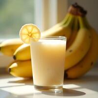 Preparing Banana Smoothie with Fresh Fruit Slice in Glass photo