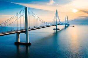 A bridge spanning across the ocean at sunset photo