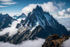 A mountain range with clouds and snow on top photo