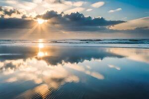 Sunset at the beach with clouds reflected in the water photo