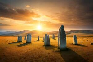 The sun is setting over a field with stone pillars photo