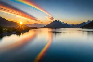 A rainbow is reflected in the water as it rises over a mountain range photo