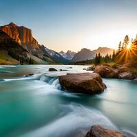 The sun rises over a mountain river in the rocky mountains photo