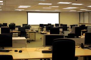 Empty computer room with numerous desks and screens. photo