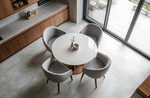 Elevated view of a modern dining area with a round table and chairs. photo