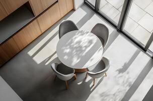 High-angle view of a modern dining area with a round table and chairs. photo